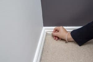 Cleaning skirting board corner with cotton bud