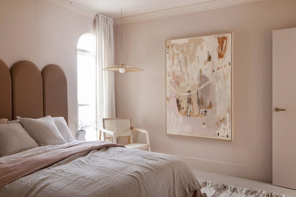 Contemporary minimalist bedroom featuring a light colour palette, soft neutral furnishings, and Intrim's SK52 skirting board for a refined aesthetic.