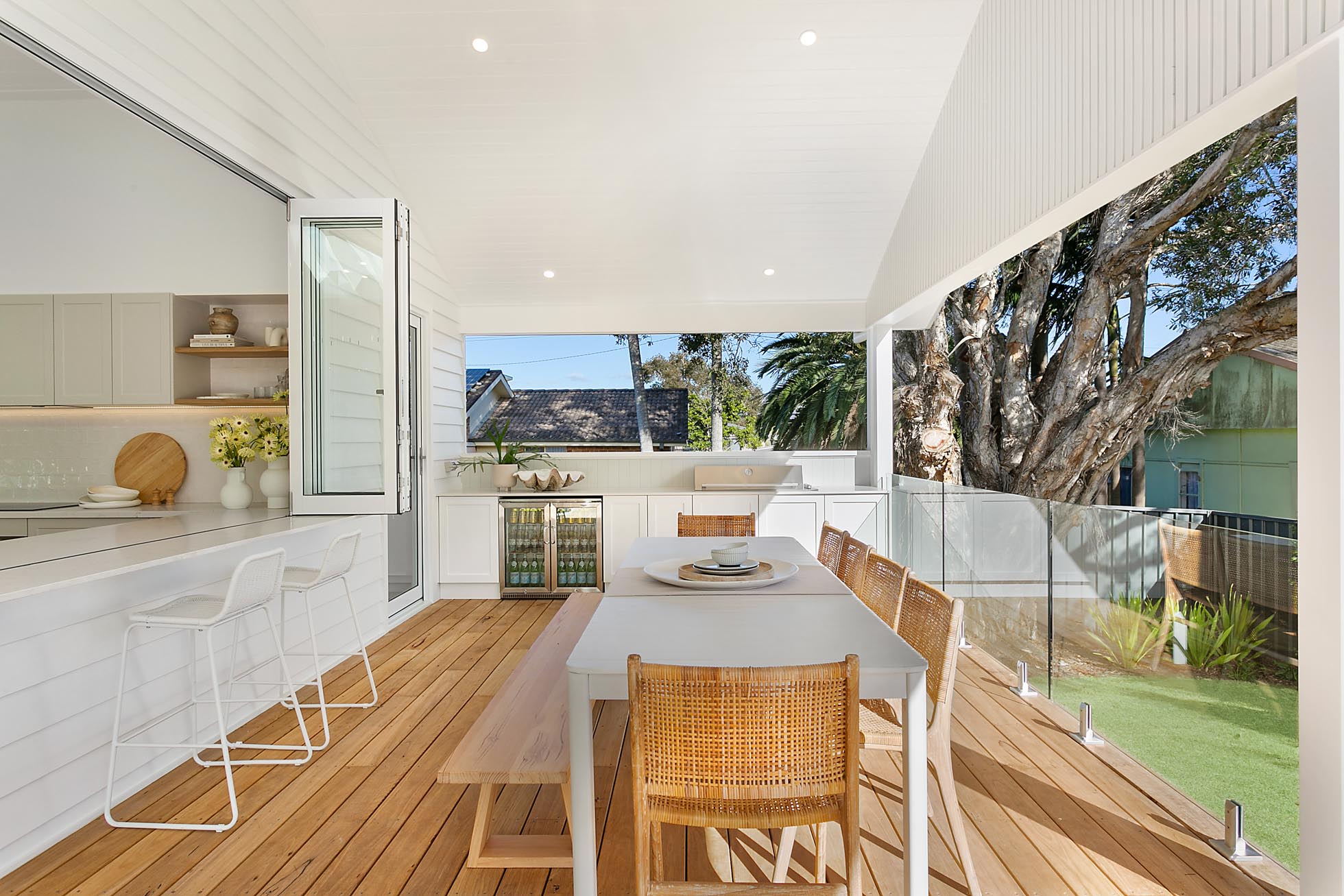 Alfresco dining area with outdoor kitchen and VJ-style ceiling featuring Intrim's tongue & groove lining boardsfor a classic coastal look