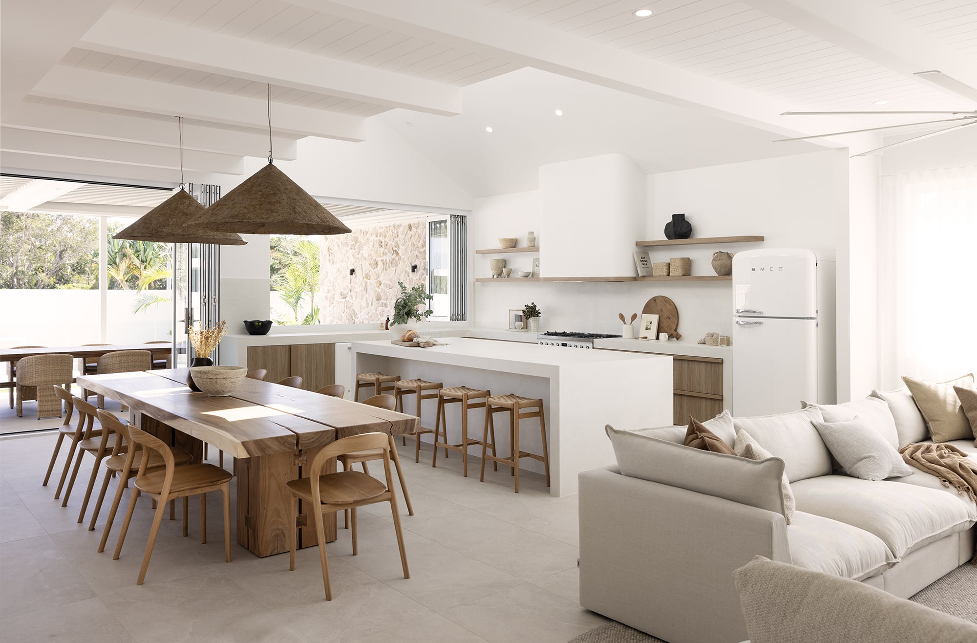 VJ-style white ceiling panels in modern farmhouse-inspired open plan kitchen and living area