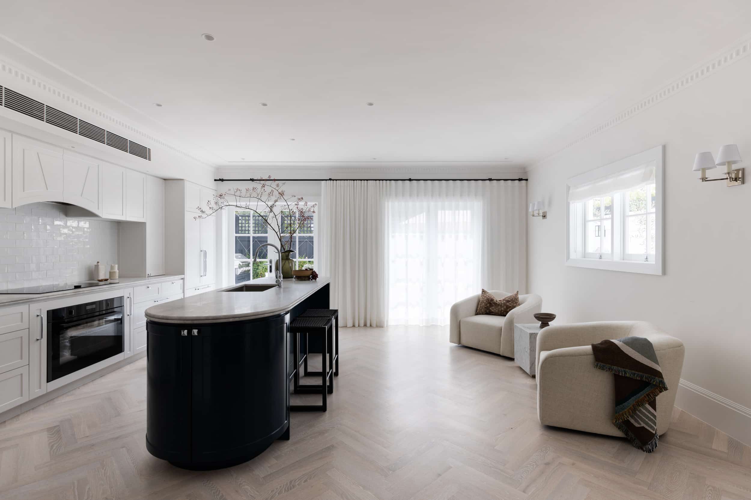 Classic white kitchen featuring decorative cornice mouldings, detailed architraves, and timber skirting boards in a light-filled Australian interior.