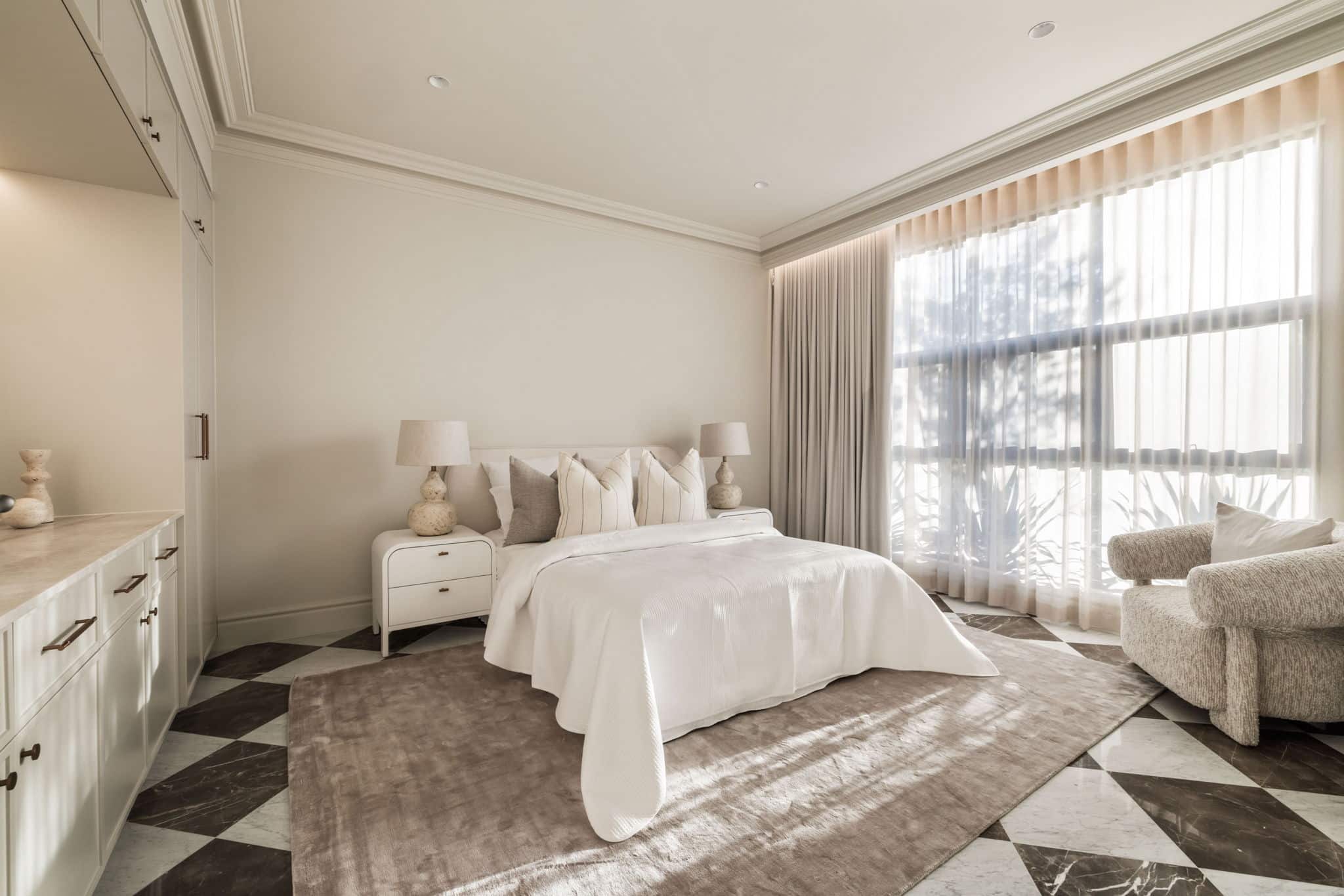 Elegant bedroom featuring classic cornices and detailed timber skirting boards, creating a soft, cohesive interior with layered architectural mouldings.