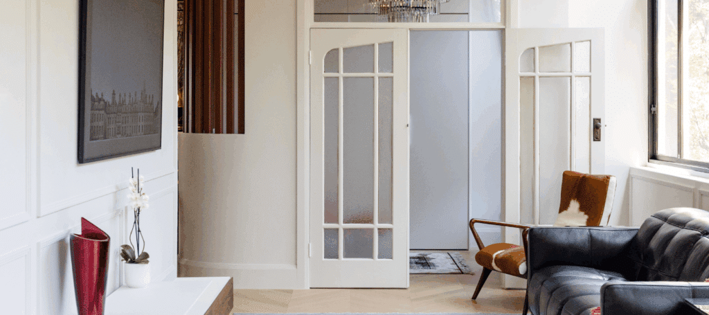 Modern Art Deco minimalist living room featuring natural timber tones, clean architectural lines, and Intrim's IN106 inlay mould for the full floor to ceiling wainscoting for a sophisticated look.