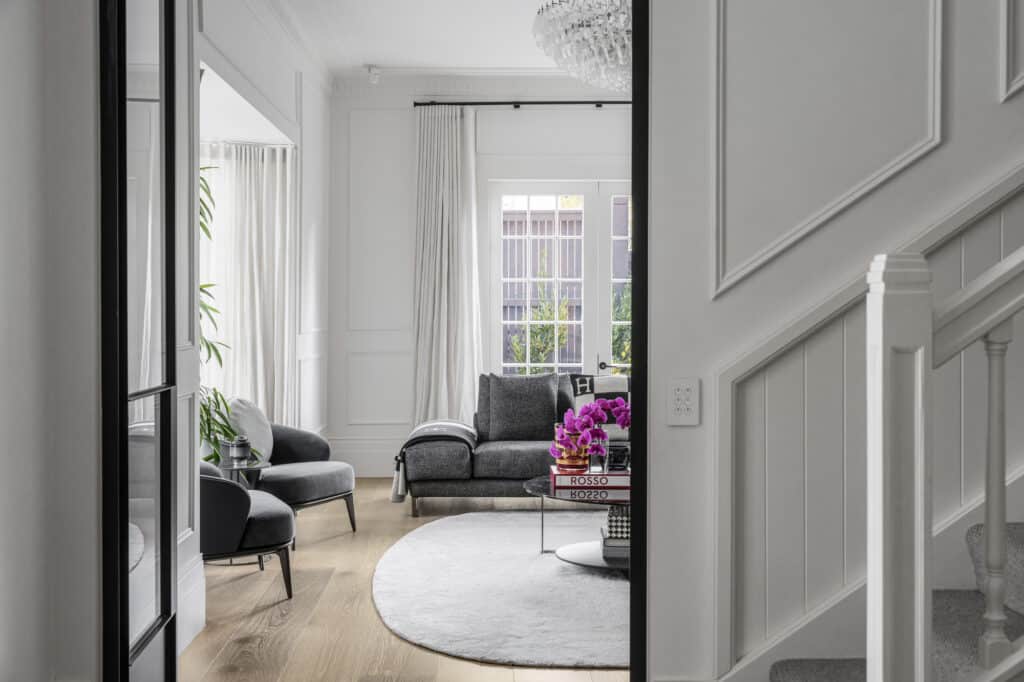 Modern living room with light timber flooring, white walls featuring Intrim wainscoting on the walls.
