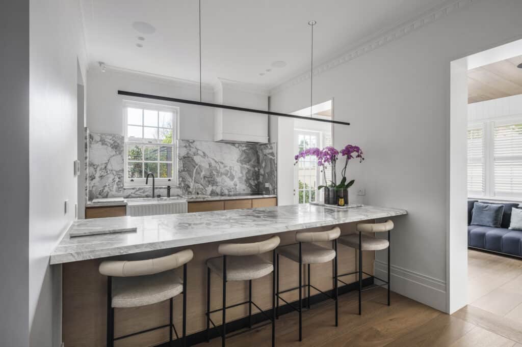 Contemporary kitchen featuring marble benchtop, pendant lighting, and Intrim's premium decorative skirting boards.