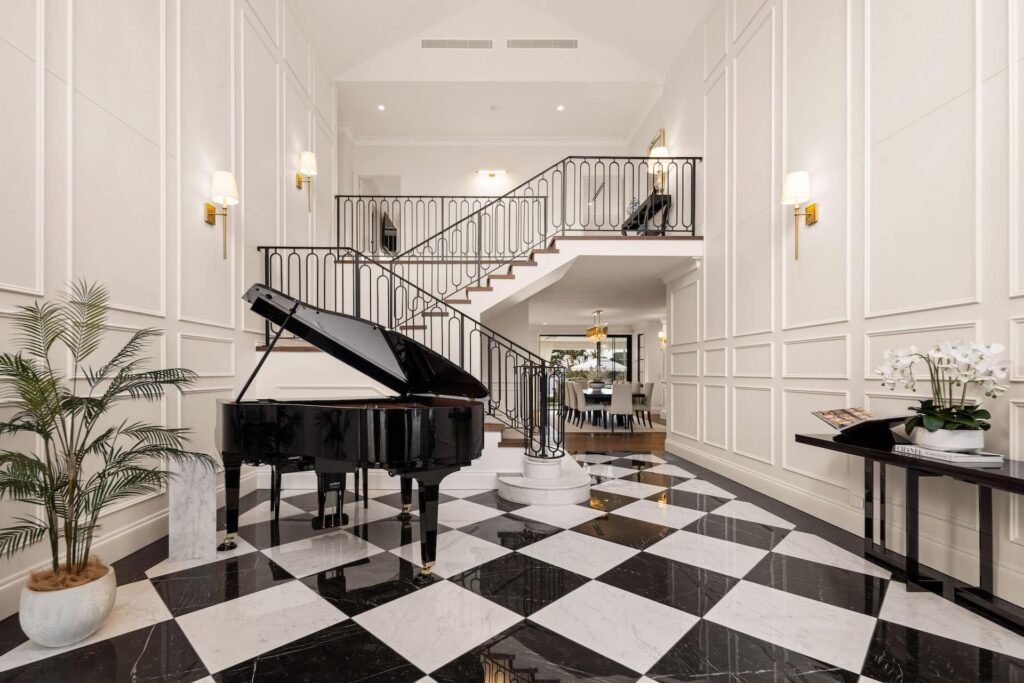 Glamourous black and white hallway featuring raised panel wainscoting
