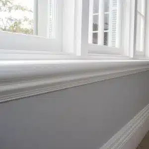 Timber sill nosing moulding detail beneath a window frame in a contemporary interior setting