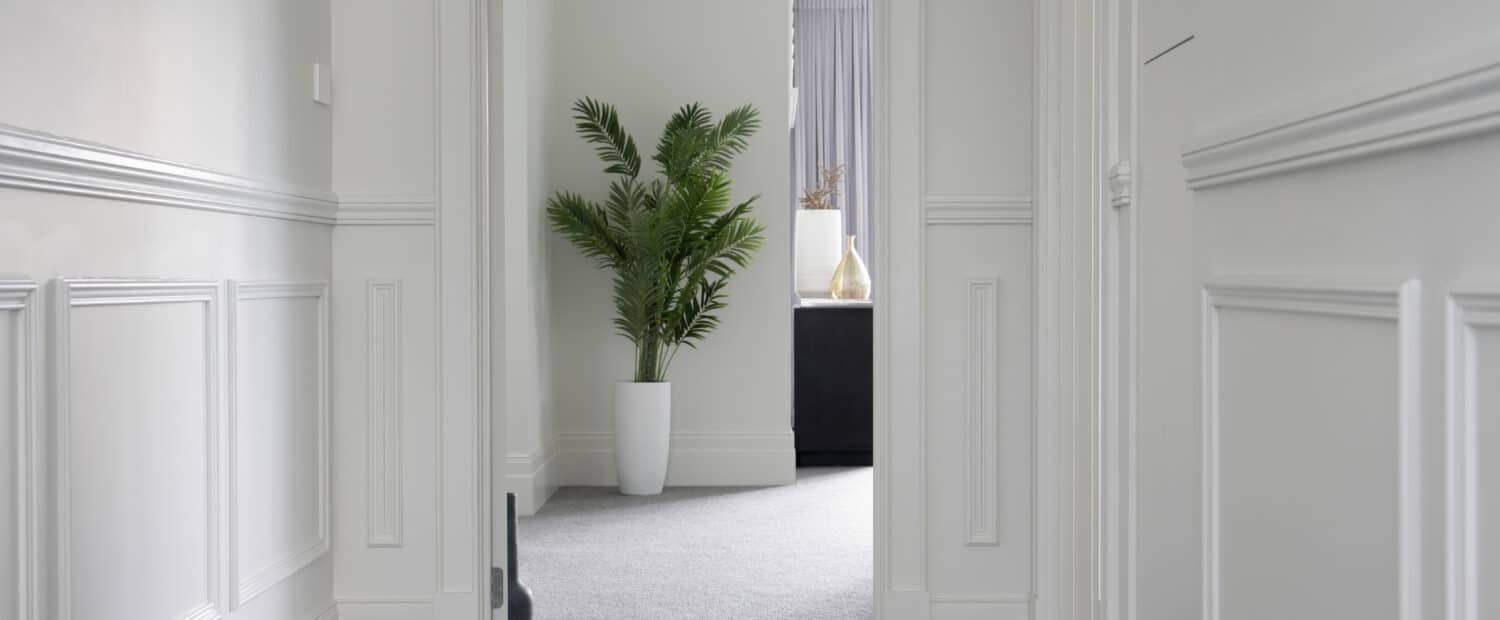 Elegant Modern Hamptons-style hallway featuring Intrim SB01 skirting block and decorative wall panelling.