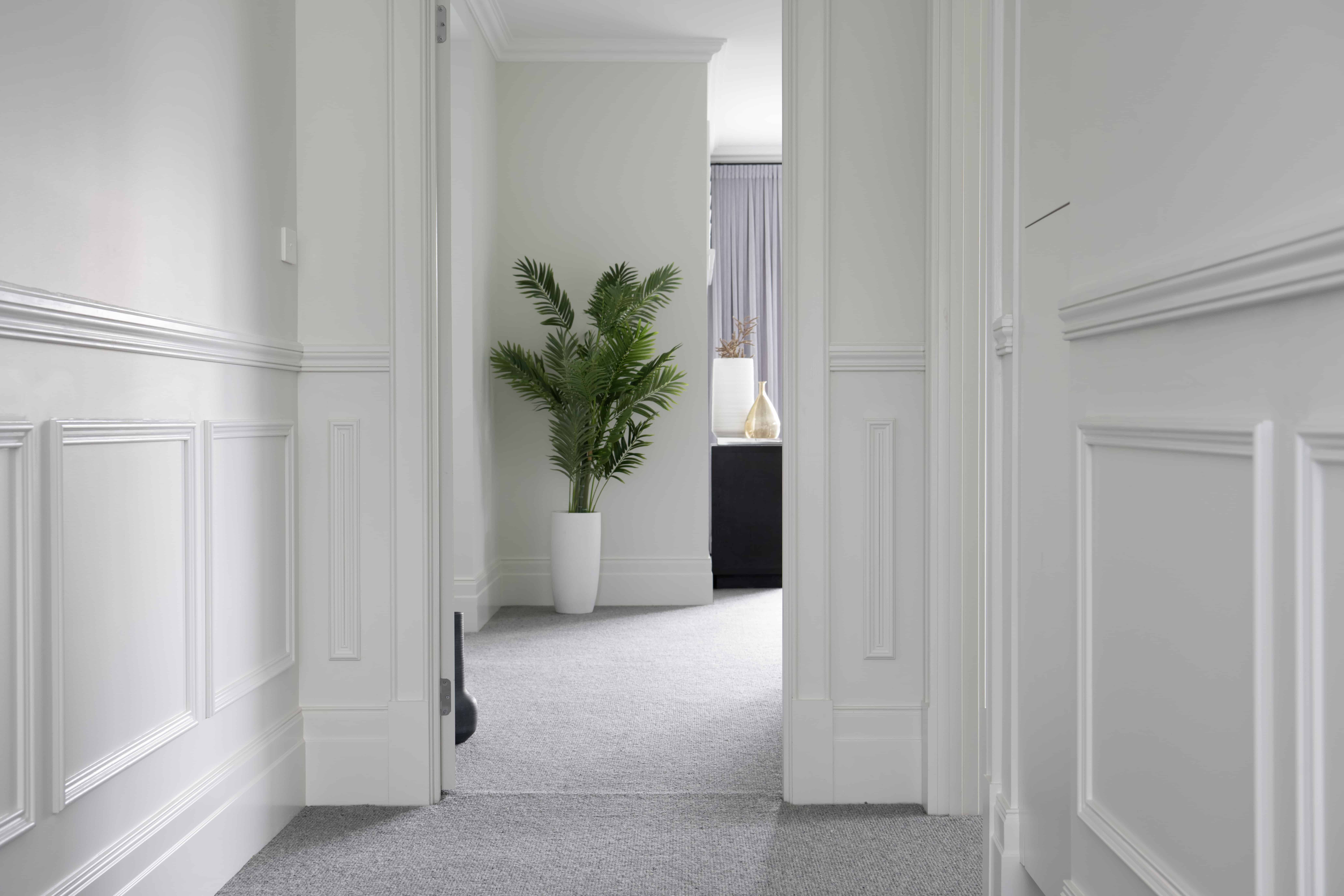 Elegant Modern Hamptons-style hallway featuring Intrim SB01 skirting block and decorative wall panelling.