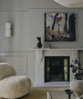 Monochromatic living room featuring painted dado rails and decorative wall mouldings, creating a seamless colour-drenched interior with layered architectural detail.