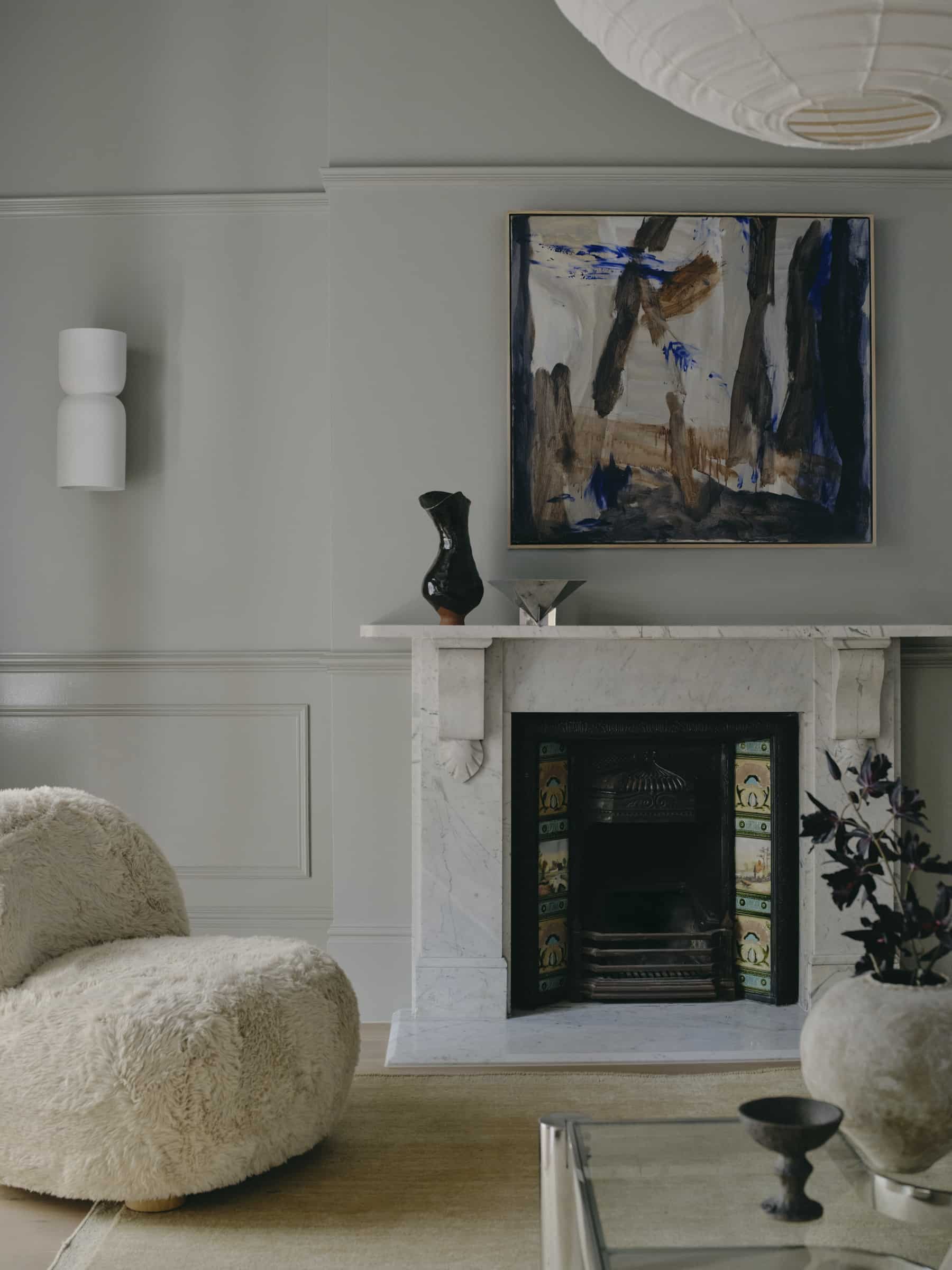 Monochromatic living room featuring painted dado rails and decorative wall mouldings, creating a seamless colour-drenched interior with layered architectural detail.