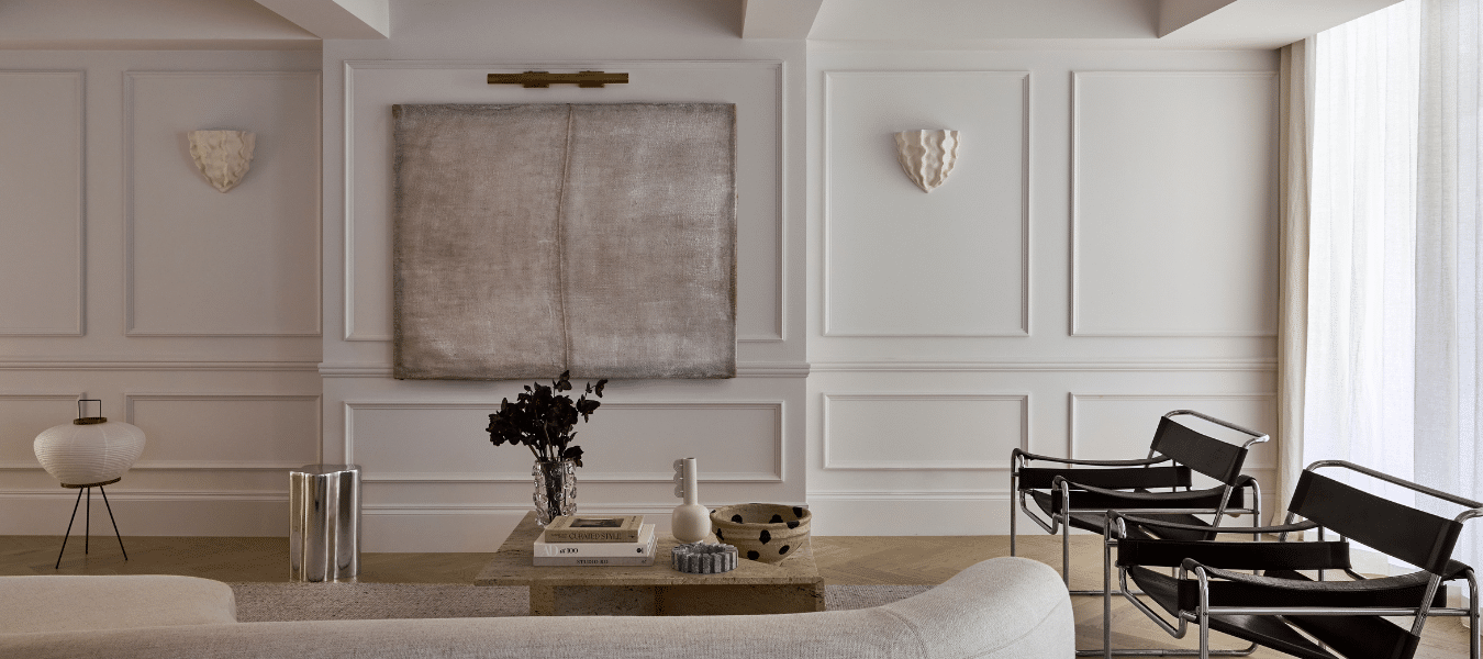 Full wall to ceiling wainscoting painted white in a French Provincial style living room.