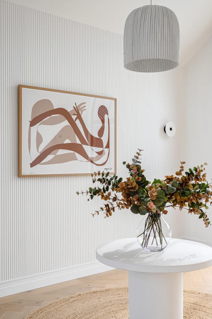 Entryway with decorative wall panelling, pendant lighting and Intrim SK1474 skirting creating a refined farmhouse aesthetic.