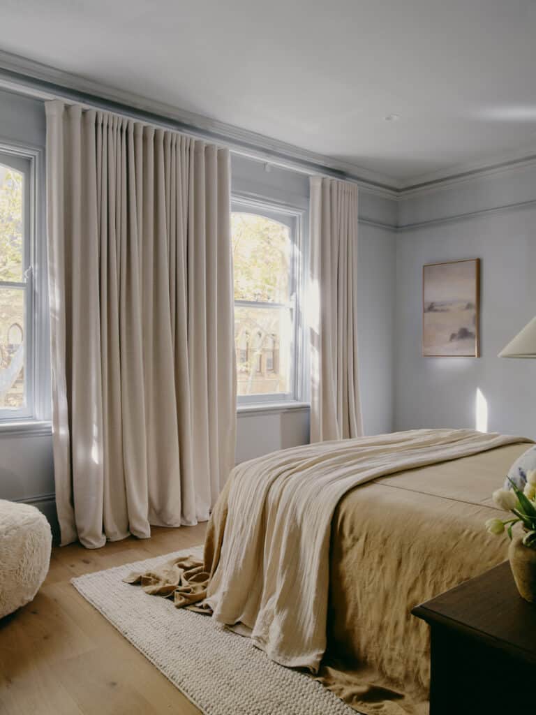 Bedroom with tall windows and ceiling cornice in Potts Point terrace renovation by Convict Interiors featuring Intrim skirting, architraves, sill nosing, and picture rail mouldings