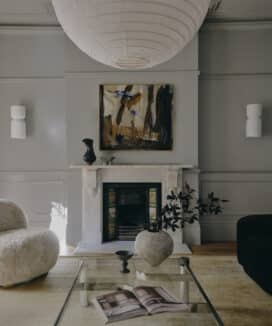 Colour drenched living room with fireplace and wall panelling in Potts Point terrace renovation by Convict Interiors featuring Intrim mouldings