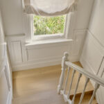 Stair landing with classic window sill nosing and wainscoting in Victorian terrace renovation by Convict Interiors using Intrim mouldings