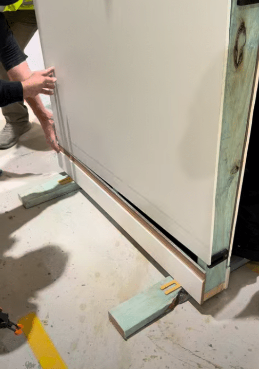 Professional installation of patented Intrim Shadowline skirting system.