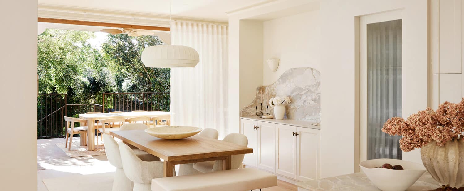 French Country kitchen and dining space in Maison Soleil featuring Intrim skirting boards, architraves and decorative mouldings, with marble benchtops, custom cabinetry and natural light.