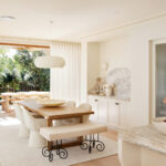 French Country kitchen and dining space in Maison Soleil featuring Intrim skirting boards, architraves and decorative mouldings, with marble benchtops, custom cabinetry and natural light.