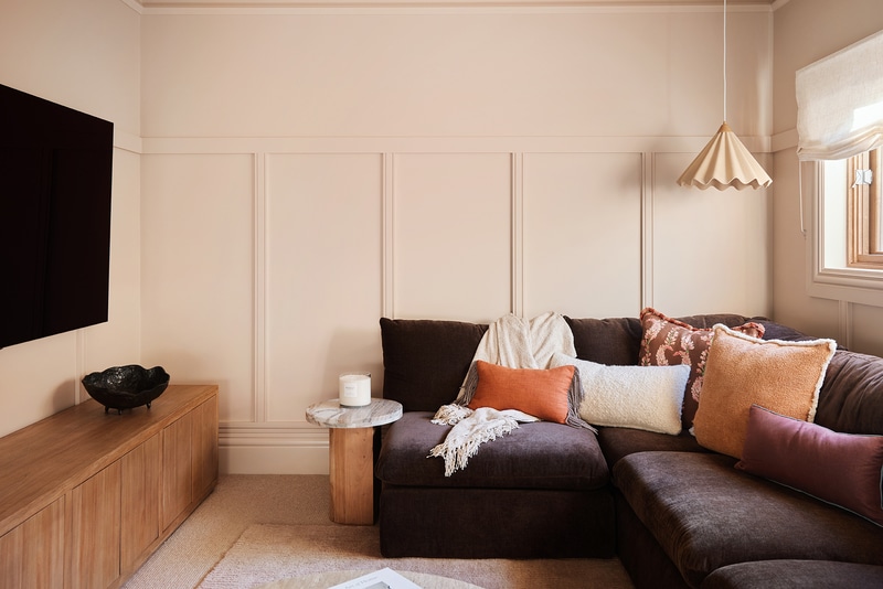 French Country media room featuring Intrim CR190 chair rail used vertically, topped with WB09 wall battens and SK945B skirting, paired with upside down SK498, with plush seating and warm layered textures.