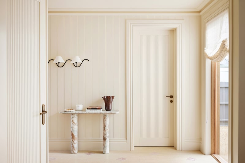Maison Soleil interior entrance featuring Intrim SK945B skirting boards and architraves, paired with fluted doors and refined French Country detailing.