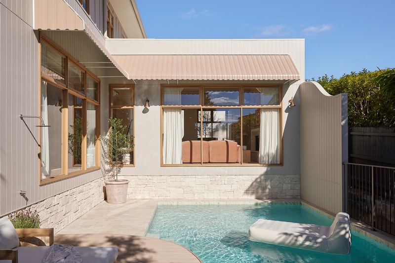 Private courtyard pool at Maison Soleil framed by French Country-inspired architecture, timber windows and soft neutral exterior finishes.