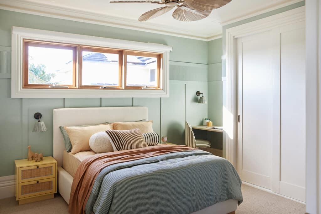 Child's bedroom at Maison Soleil featuring Intrim SK945B skirting and architraves, LB35 fluted wall battens, WB09 wall batten panelling and a custom study nook in soft sage-green tones.