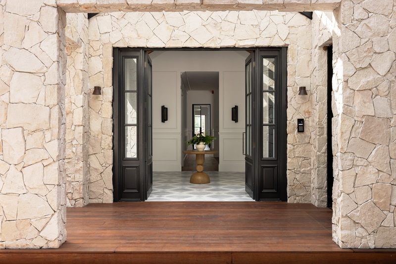 Stone-clad farmhouse entrance framing interiors finished with Intrim wall panelling and mouldings