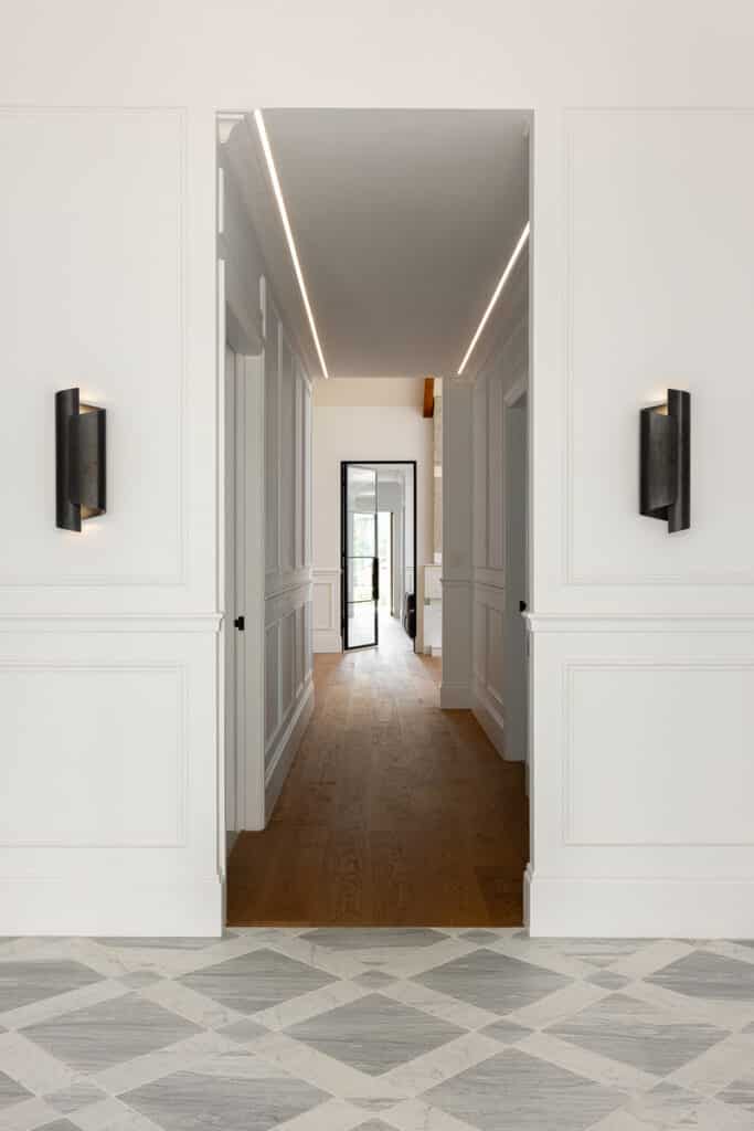 Transition space featuring Intrim SK498 architraves, decorative wall mouldings and marble tiled flooring